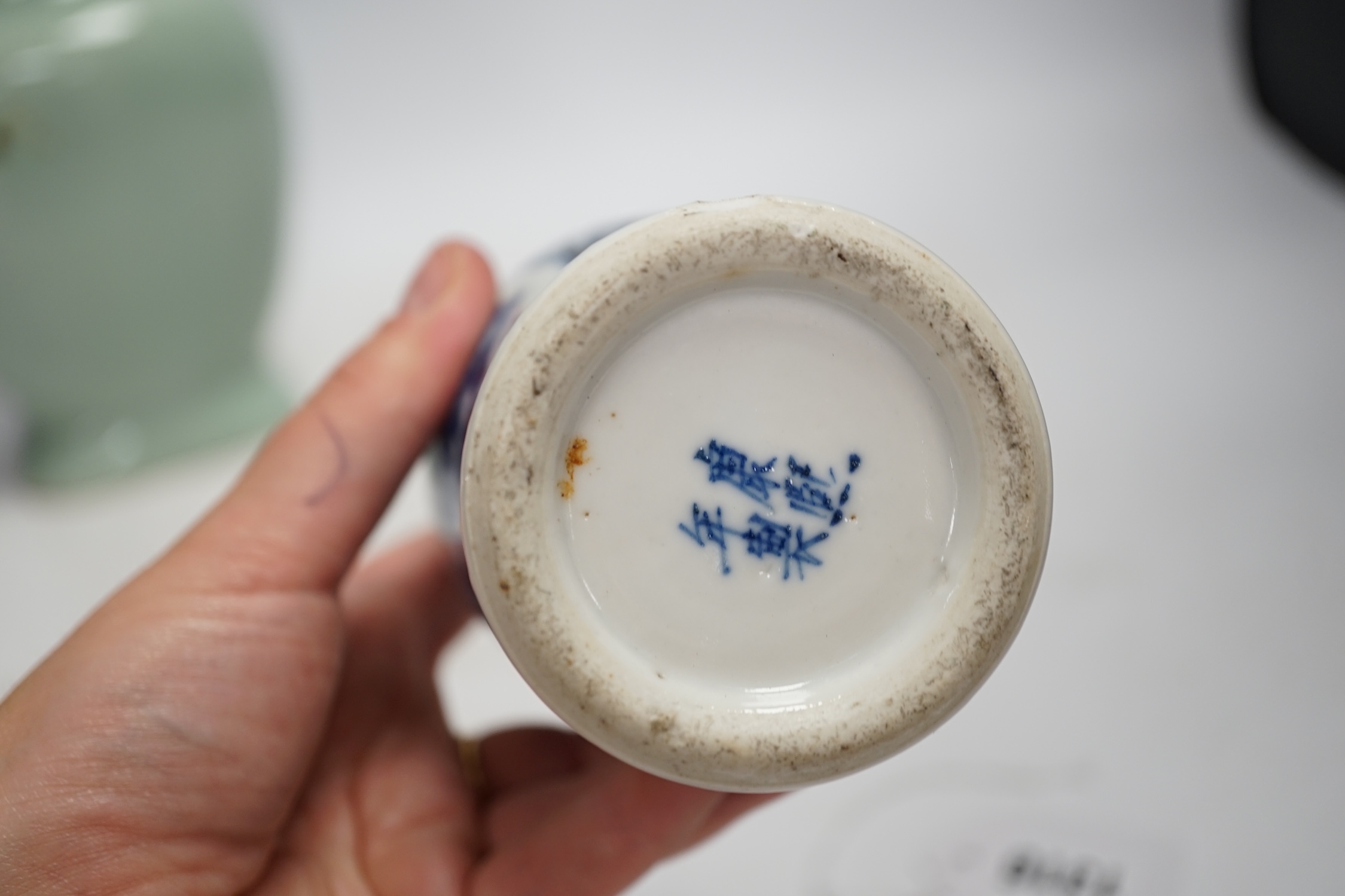 A Chinese celadon glazed two handled vase and a Chinese blue and white vase and dish, celadon vase 28.5cm high. Condition - celadon vase has a firing flaw and large crack, both blue and white vase are in damaged conditio
